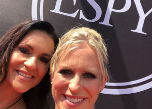 nicole and a woman friend in front of the espy sign