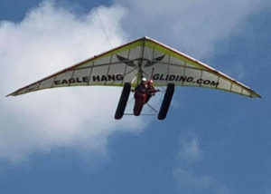hang glider flying through the sky