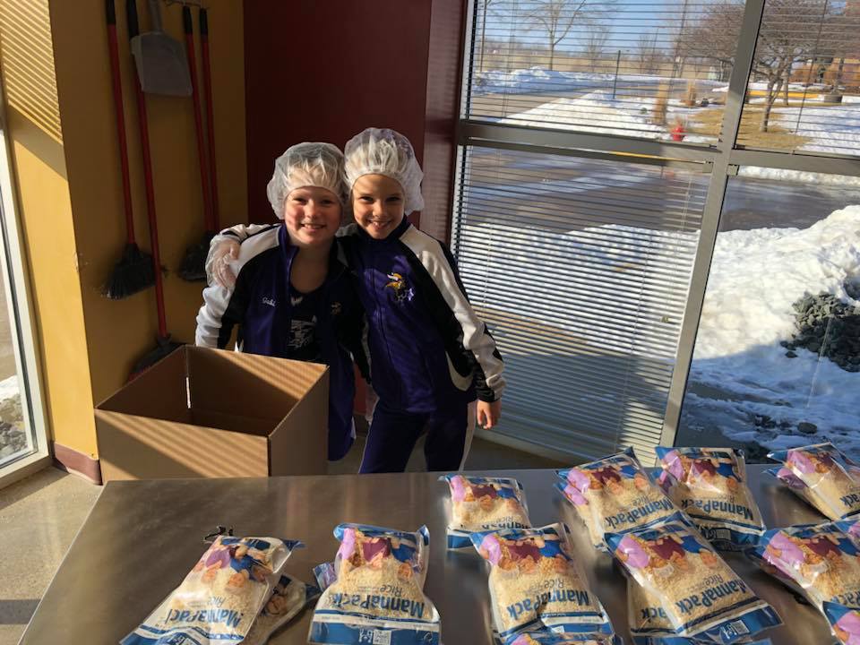 full picture of nicole and daughter at feed my starving children working