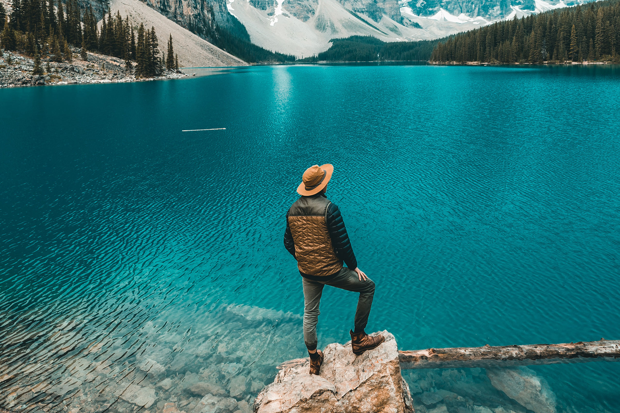 Man Standing by Glacial lake